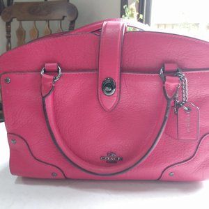 Pink and black coach purse